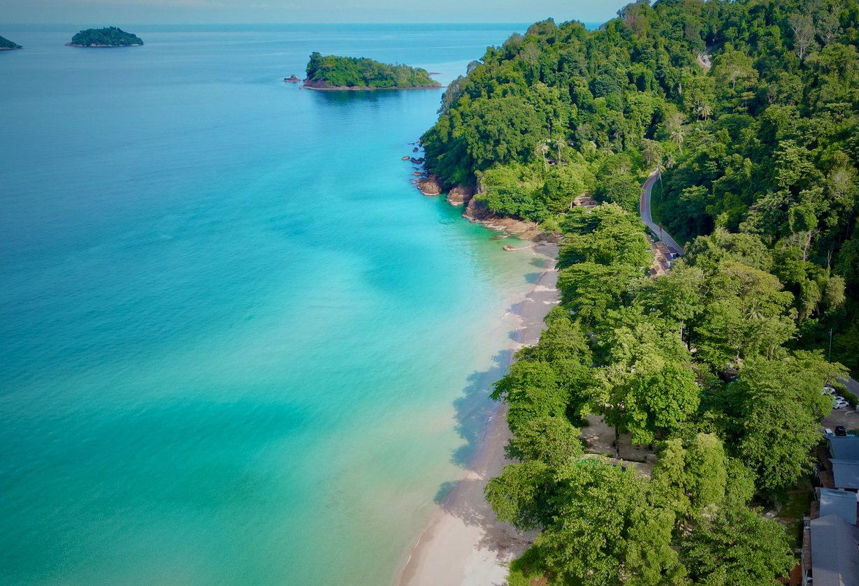 Drone view of Koh Chang west coast, rainforest road and clear tropical sea