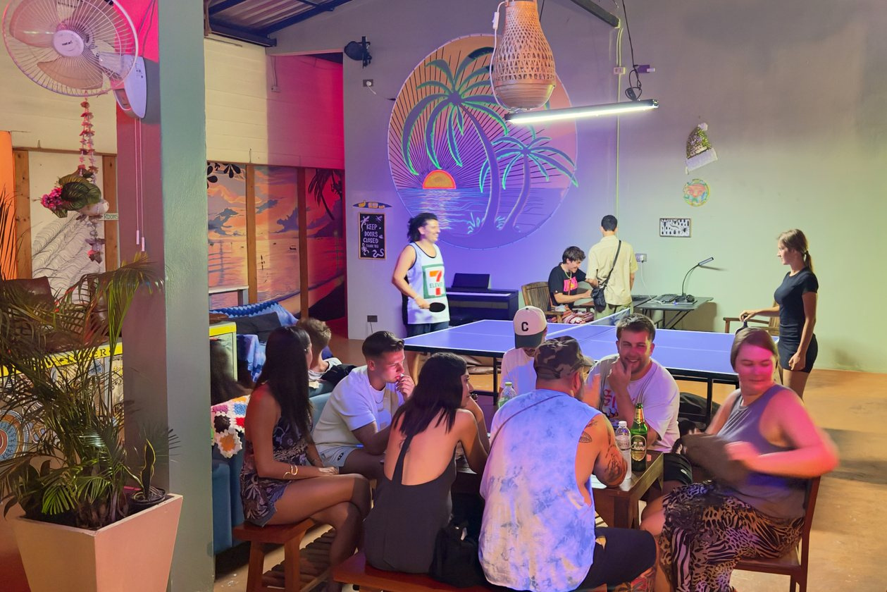 Travellers relaxing and playing ping pong in the Beach Jungle social lounge